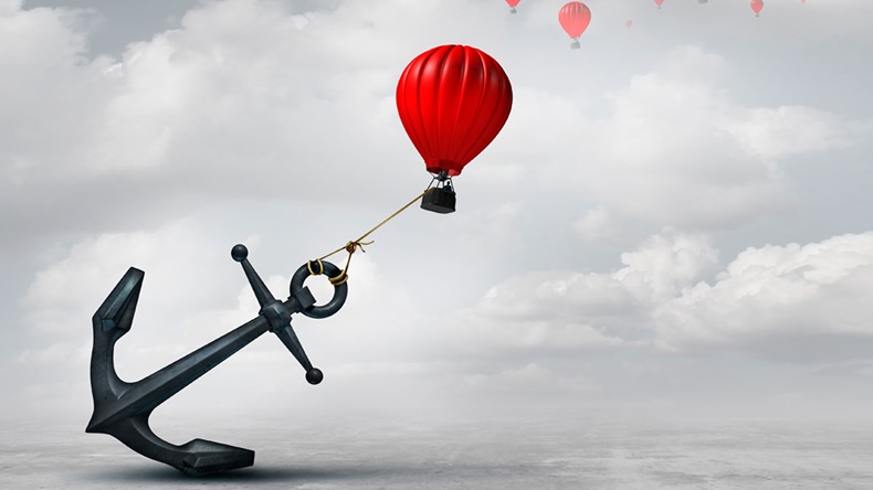 Held back metaphor as a large anchor holding or oppressing an air balloon and restricting movement as a suppression business metaphor from aspiring to succeed with 3D illustration elements.