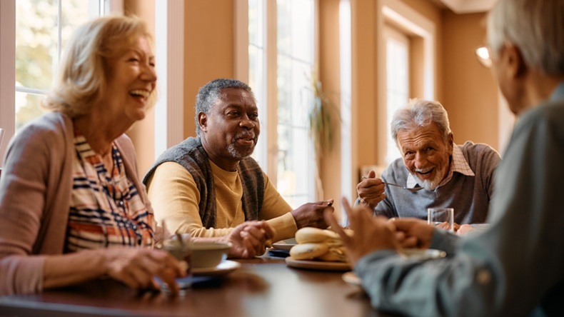 group of diverse senior citizens sitting around a table 