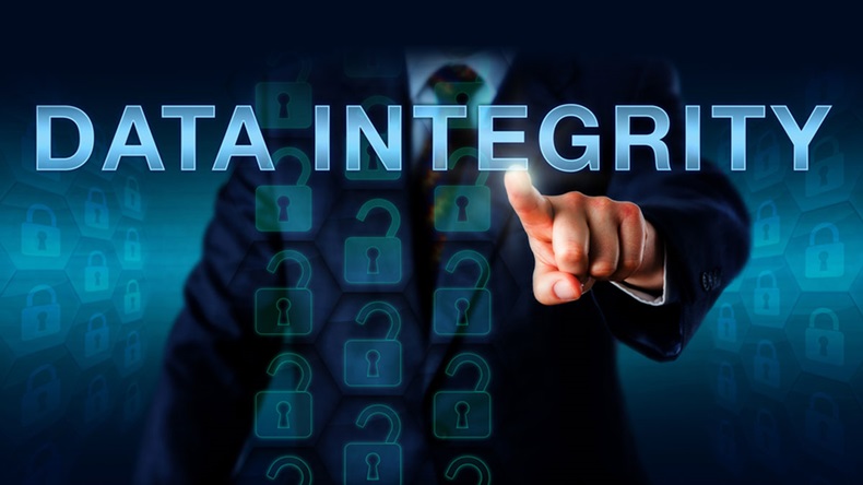 IT manager is pushing DATA INTEGRITY onscreen. Technology and business concept. Self-repeating datasets represented by locked hexagon icons refer to the assurance of accuracy and consistency of data.