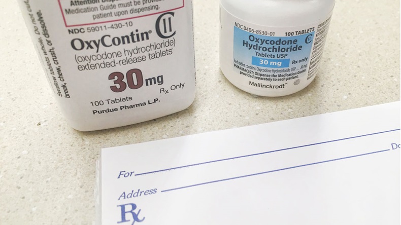 July 29, 2018-ogden Utah, USA: OxyContin and oxycodone bottle on counter with rx prescription pad. These drugs have been leading to abuse and overdose. - Image 