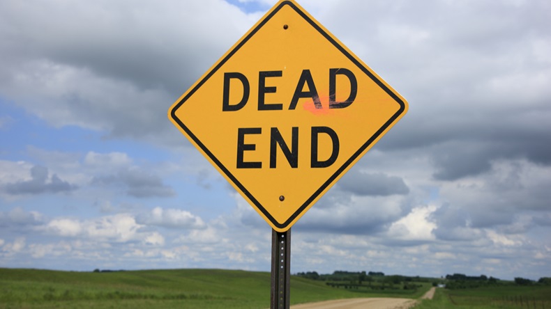 A Dead End sign posted along a rural gravel road. - Image 