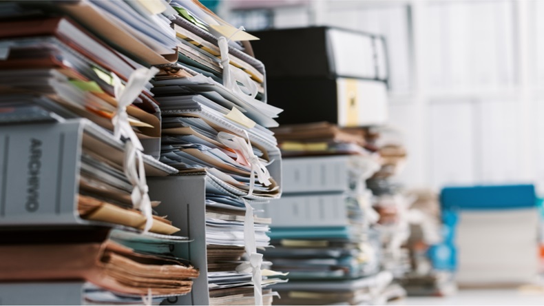 Stacks of paperwork and files in the office: work overload, files management and administration concept - Image 