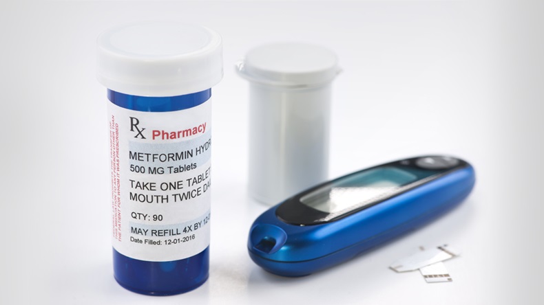 Metformin prescription bottle, glucometer and test strips.
