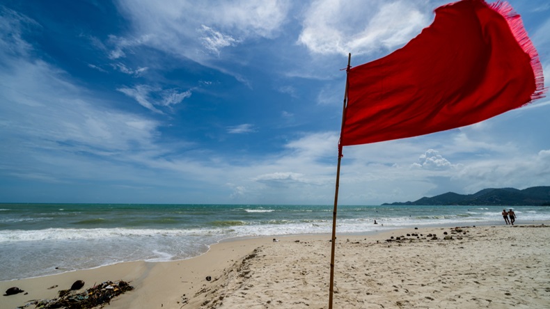 "No Swimming" signs & red flags posted due to riptide, undertow & big waves at Koh Samui, Thailand beach