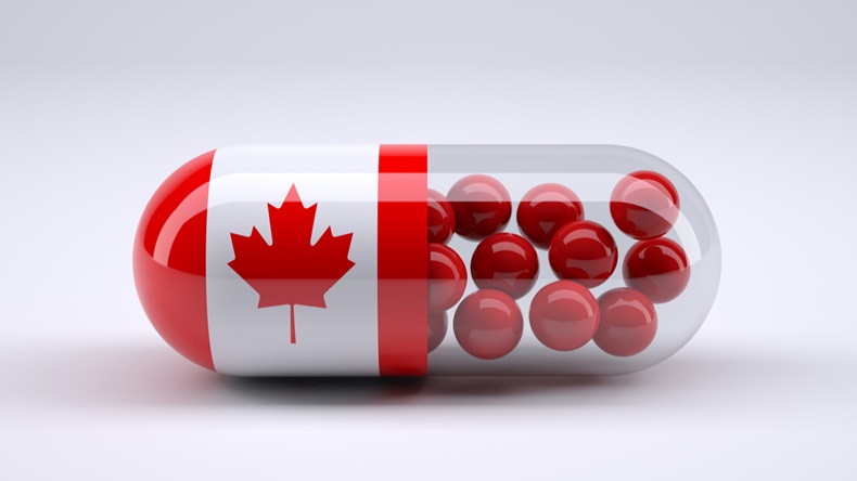 Pill with Canadian flag wrapped around it and red ball inside