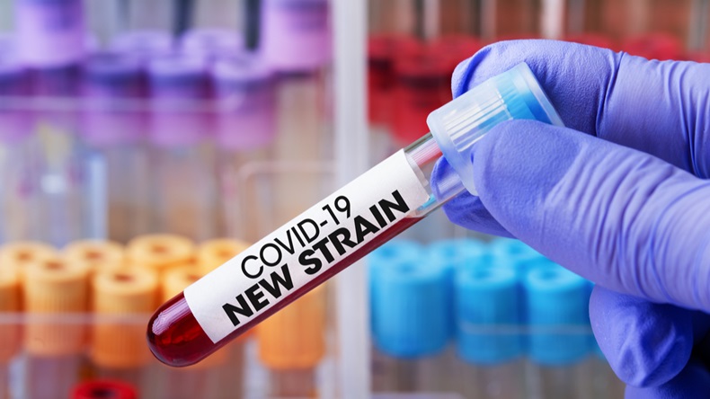 Doctor in the lab holding a tube of blood identified with the label Covid-19 New Strain. Laboratory Technician with a blood sample with a new variant of the Coronavirus