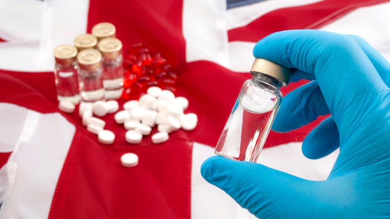 Medicine shortages, stockpile drugs and medical crisis as result of no deal brexit concept theme with doctor wearing latex gloves holding a vaccine with the UK flag in background and other medicines