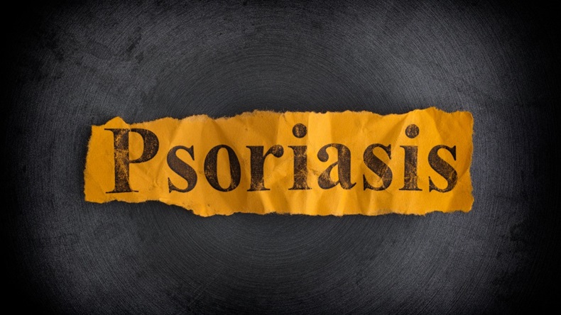 Torn piece of yellow paper with the word Psoriasis