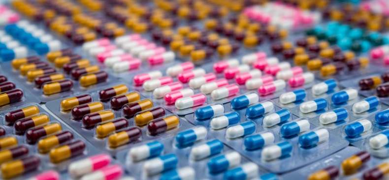 Selective focus on colorful antibiotic capsule pills in blister pack. Antibiotic drug resistance. Pharmaceutical industry. Pharmacy drug store backgro