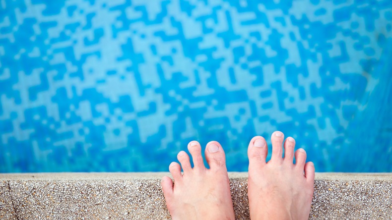 feet at edge of pool