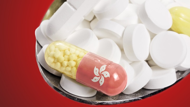 The national flag of Hong Kong on a capsule and pills on a spoon