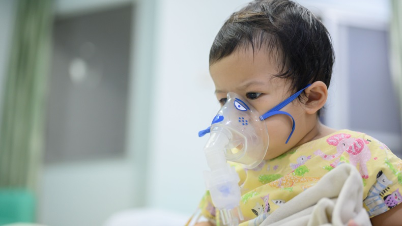 infant in doctor's office with mask to help them breath 