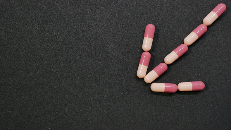 pink pills down arrow