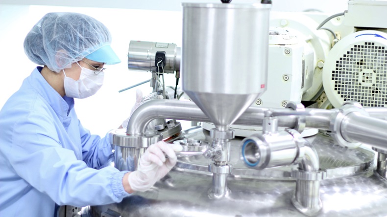 person working in drug manufacturing facility 