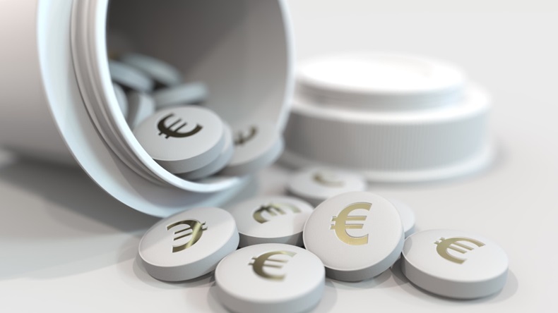 Close-up shot of pills with stamped euro symbol on them.