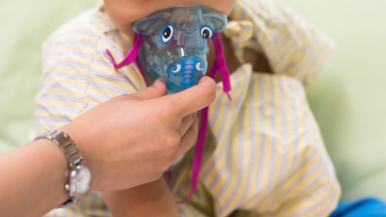 Patient child do inhalation with mask on his face to heal RSV (Respiratory Syncytial Virus)