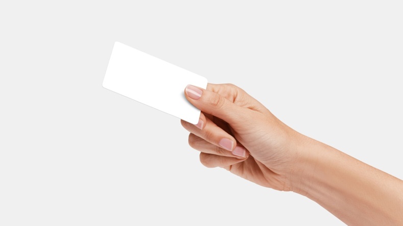 Woman's hand showing credit card, or card, or business card or voucher,