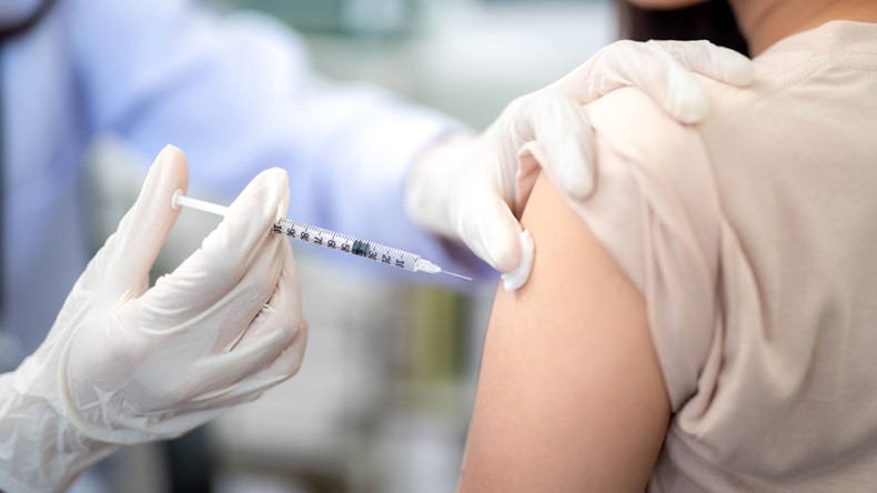 Close up of doctor making a vaccination in the shoulder of patient