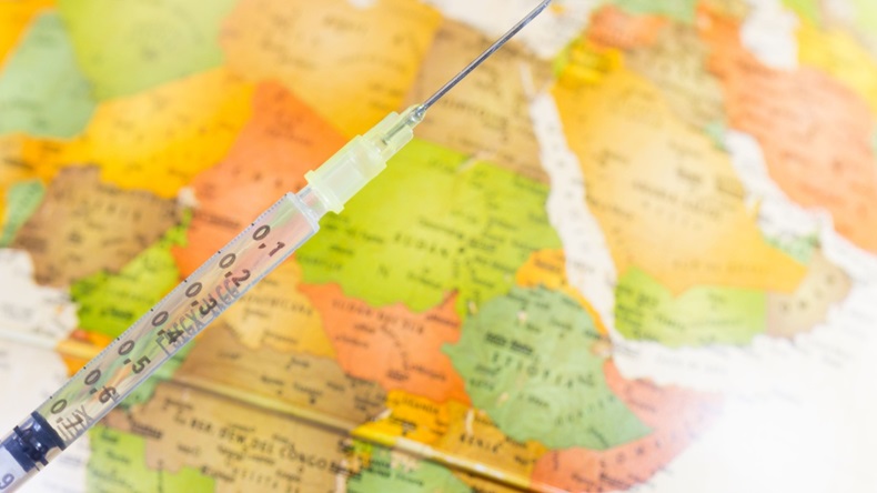 Syringe with vaccine with map of Africa background