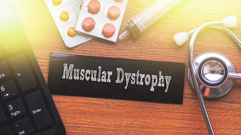 MUSCULAR DYSTROPHY words written on label tag with medicine,syringe,keyboard and stethoscope