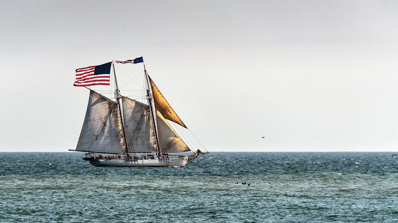 Large US American flag on sailboat off the coast of California